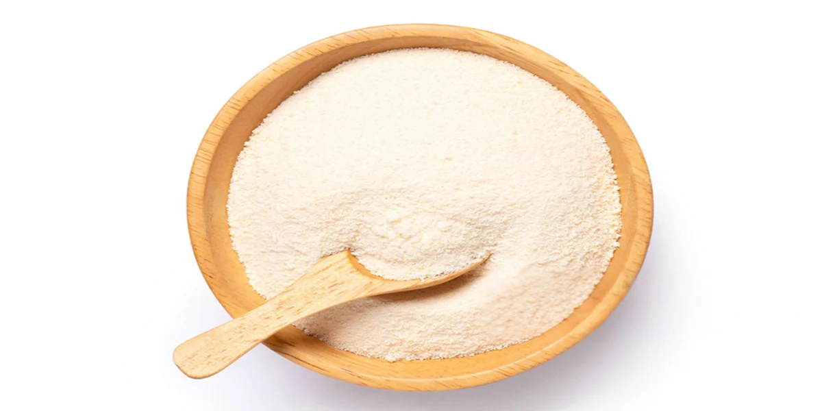 Maltodextrin powder in wooden bowl with scoop