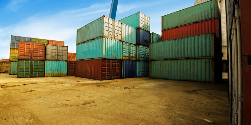 Stacked shipping containers at industrial logistics yard